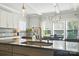 Kitchen island includes granite countertops, bar seating, stainless steel appliances, modern lighting, and backsplash at 2246 Bluebell Way, Fort Mill, SC 29708