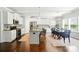 Open-concept kitchen with a center island, stainless appliances, white cabinets, and adjoining dining area at 2246 Bluebell Way, Fort Mill, SC 29708