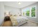 Bedroom with large window offering plenty of light, with a bed and two end tables at 2246 Bluebell Way, Fort Mill, SC 29708