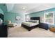 Spacious main bedroom with tray ceiling, natural light, sitting chair and furnishings at 2246 Bluebell Way, Fort Mill, SC 29708