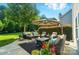 Enjoy outdoor living on this patio with seating, greenery, and a large shade umbrella at 2246 Bluebell Way, Fort Mill, SC 29708