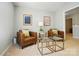 Sitting room showcasing two modern chairs, glass tables, artwork, and carpeted floor at 2246 Bluebell Way, Fort Mill, SC 29708
