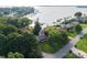 An aerial view shows a lakeside property with mature trees and well-manicured lawns at 22501 John Gamble Rd, Cornelius, NC 28031