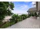 Expansive back deck overlooking a serene waterfront, complete with lush tropical landscaping and outdoor seating at 22501 John Gamble Rd, Cornelius, NC 28031