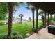 Lush backyard showcasing a waterfront view framed by palm trees, with a pathway leading to the water at 22501 John Gamble Rd, Cornelius, NC 28031