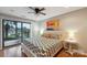 Inviting bedroom with wood floors, a ceiling fan, and sliding glass doors leading to an outdoor deck at 22501 John Gamble Rd, Cornelius, NC 28031