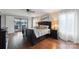 Comfortable main bedroom boasts a private balcony and hardwood floors at 22501 John Gamble Rd, Cornelius, NC 28031