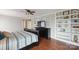 Bedroom features dark wood floors, white built-ins, and custom accents at 22501 John Gamble Rd, Cornelius, NC 28031