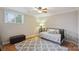 Bright bedroom with a decorative rug, a ceiling fan, and a window providing natural light and ventilation at 22501 John Gamble Rd, Cornelius, NC 28031