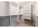 Walk-in closet featuring white shelving, and metal clothes rods, providing ample storage space for an organized wardrobe at 22501 John Gamble Rd, Cornelius, NC 28031