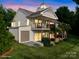 An exterior showcases a home with a balcony, covered patio, well manicured lawn, and a two-car garage at 22501 John Gamble Rd, Cornelius, NC 28031