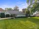 One-story home featuring manicured lawn and a convenient carport, offering both style and functionality at 22501 John Gamble Rd, Cornelius, NC 28031