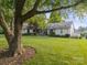 Beautifully landscaped front yard with mature trees and a well-maintained one-story home at 22501 John Gamble Rd, Cornelius, NC 28031