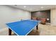 Spacious game room featuring a ping pong table and red-patterned chairs, perfect for Gathering fun at 22501 John Gamble Rd, Cornelius, NC 28031