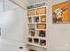 Hallway featuring built in white shelving with decor and painting of cow hanging on the wall at 22501 John Gamble Rd, Cornelius, NC 28031