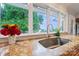 Kitchen sink with stainless steel faucet and view of trees at 22501 John Gamble Rd, Cornelius, NC 28031