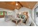 Bright living room boasts vaulted wood ceilings and seamlessly connects to the kitchen at 22501 John Gamble Rd, Cornelius, NC 28031