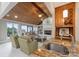 This gorgeous living room area features a fireplace, wood ceilings, and a full kitchen at 22501 John Gamble Rd, Cornelius, NC 28031
