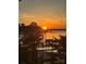 Stunning sunset view over the water, with docks and palm trees enhancing the serene landscape at 22501 John Gamble Rd, Cornelius, NC 28031