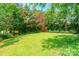 Expansive backyard featuring a well-maintained lawn and privacy provided by mature trees at 2363 Sanderling Dr, Rock Hill, SC 29732