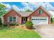 Charming brick home featuring a two-car garage, manicured lawn, and lovely landscaping details at 2363 Sanderling Dr, Rock Hill, SC 29732