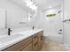 Modern bathroom featuring double sinks, and soaking tub/shower with marble tile at 2413 Pruitt St, Charlotte, NC 28208