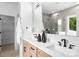 Modern bathroom featuring a double vanity, matte black fixtures, and large mirror at 2413 Pruitt St, Charlotte, NC 28208
