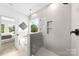 Clean bathroom showcasing a glass shower, soaking tub, and neutral tile at 2413 Pruitt St, Charlotte, NC 28208