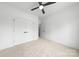 Modern bedroom featuring a large closet with white doors and carpeted floors at 2413 Pruitt St, Charlotte, NC 28208
