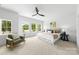 Bright bedroom with large windows, plush carpet, modern ceiling fan, and stylish decor at 2413 Pruitt St, Charlotte, NC 28208