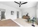 Bright bedroom featuring neutral carpet, decor, and a large black ceiling fan at 2413 Pruitt St, Charlotte, NC 28208
