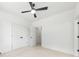 Bright bedroom featuring neutral carpet and white walls, as well as two closet doors and a ceiling fan at 2413 Pruitt St, Charlotte, NC 28208