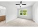Bright bedroom with neutral carpet, ceiling fan, and a double window allowing plenty of natural light at 2413 Pruitt St, Charlotte, NC 28208