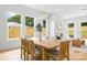 Bright dining room featuring an elegant wood table set with seating for six and decorative modern light fixture at 2413 Pruitt St, Charlotte, NC 28208