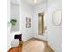 Bright foyer featuring light wood floors, a modern mirror, and built-in shelving with stylish decor at 2413 Pruitt St, Charlotte, NC 28208
