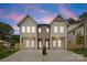 Exterior view of modern townhomes with two-story facades and a shared driveway approach at 2413 Pruitt St, Charlotte, NC 28208