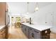 Open-concept kitchen with a large island, stainless steel appliances, and seamless flow to the dining area at 2413 Pruitt St, Charlotte, NC 28208