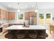 Modern kitchen with a large island, breakfast bar, stainless steel appliances, and modern pendant lights at 2413 Pruitt St, Charlotte, NC 28208