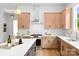 Well-lit kitchen features stainless steel appliances, light wood cabinets, and a white countertop for meal preparation at 2413 Pruitt St, Charlotte, NC 28208