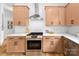Beautiful kitchen features stainless appliances, gas range, white countertops, and light wood cabinets at 2413 Pruitt St, Charlotte, NC 28208