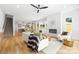 Expansive open concept living room with a fireplace, modern decor, and seamless flow to the dining area at 2413 Pruitt St, Charlotte, NC 28208