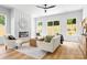 Sun-filled living room with a fireplace, modern decor, ample natural light, and views of the backyard at 2413 Pruitt St, Charlotte, NC 28208
