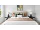 Close-up of the main bedroom's beautifully appointed bed with decorative pillows and stylish bedside tables at 2413 Pruitt St, Charlotte, NC 28208