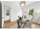 Home office with a desk, modern lighting, a view of the backyard, and a doorway to another room at 2413 Pruitt St, Charlotte, NC 28208
