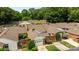 Aerial view of townhomes with brick exteriors, manicured lawns and mature landscaping at 2419 Quail Lake Dr, Charlotte, NC 28210