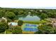 Aerial view of community amenities including a lake, swimming pool, and blue tennis courts at 2419 Quail Lake Dr, Charlotte, NC 28210