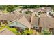 View of a residential community with brown roofs and a parking area surrounded by lush greenery at 2419 Quail Lake Dr, Charlotte, NC 28210