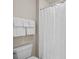 Close up view of the toilet, towels and shower curtain in the bathroom of the home at 2419 Quail Lake Dr, Charlotte, NC 28210