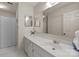Bright bathroom featuring white vanity with ample counter space, large mirror, and shower with curtain at 2419 Quail Lake Dr, Charlotte, NC 28210