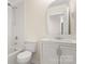Clean bathroom featuring white subway tile, vanity, and a shower-tub combo at 2448 Sweet Birch Ct, Gastonia, NC 28054